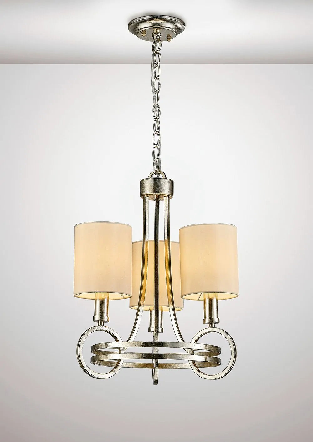 A Diyas IL31701 Isabella Pendant with a beige shade and three E14 lights is plated in antique silver.